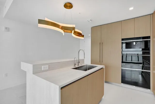 a kitchen with stainless steel appliances granite countertop a sink and a stove