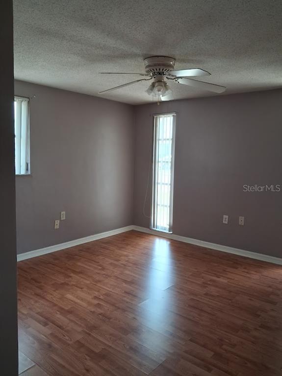 6821 Mesa Verde Street Port Richey, FL 34668 - Photo 12 of 19 a view of an empty room with a window and wooden floor