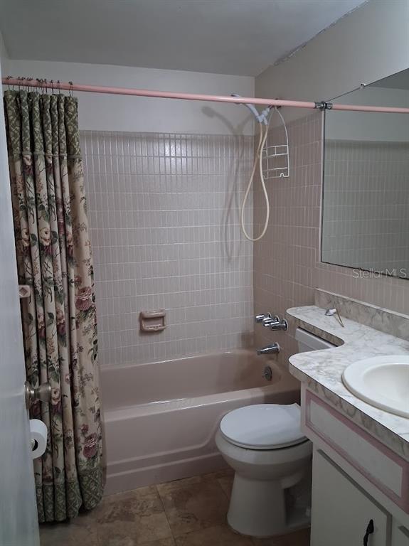 6821 Mesa Verde Street Port Richey, FL 34668 - Photo 15 of 19 a bathroom with a shower a toilet and sink