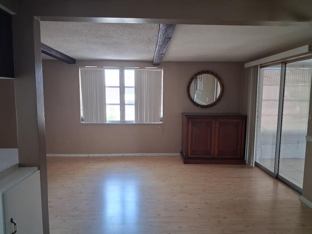 6821 Mesa Verde Street Port Richey, FL 34668 - Photo 5 of 19 an empty room with wooden floor and windows