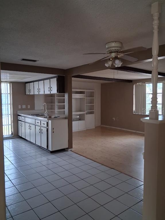 6821 Mesa Verde Street Port Richey, FL 34668 - Photo 6 of 19 a living room with a cabinet and a chandelier