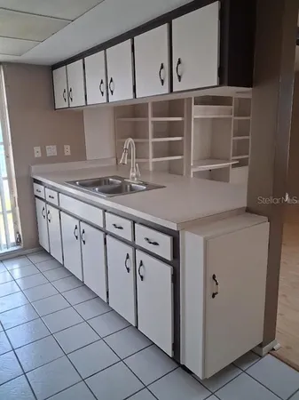 a kitchen with stainless steel appliances granite countertop a sink and a stove