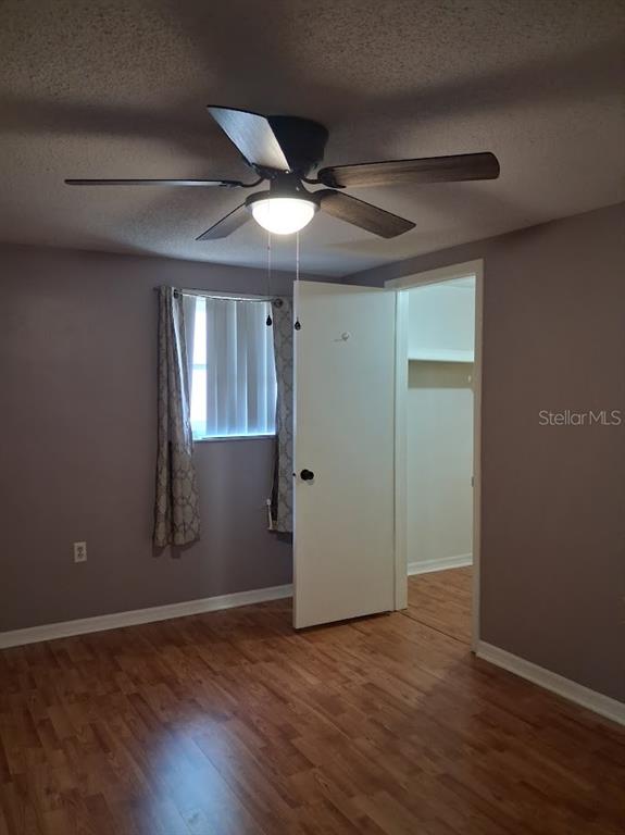 6821 Mesa Verde Street Port Richey, FL 34668 - Photo 10 of 19 an empty room with wooden floor and windows