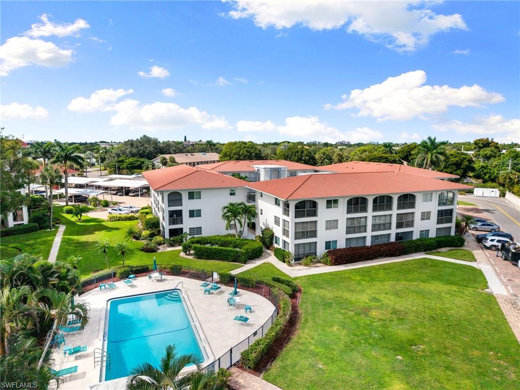 5 High Point Circle West, Unit 307 Naples, FL 34103 - Photo 28 of 31 Aerial view of a pool