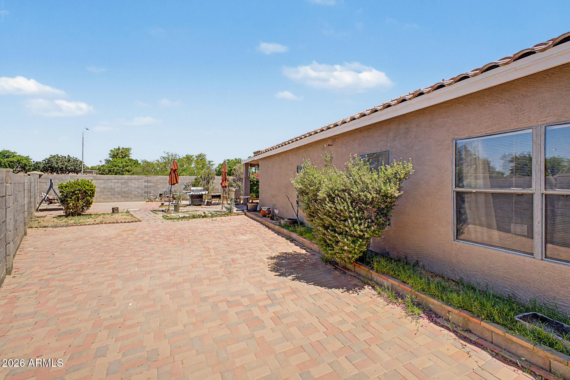 9730 West Payson Road Tolleson, AZ 85353 - Photo 30 of 57 a patio with table and chairs and potted plants
