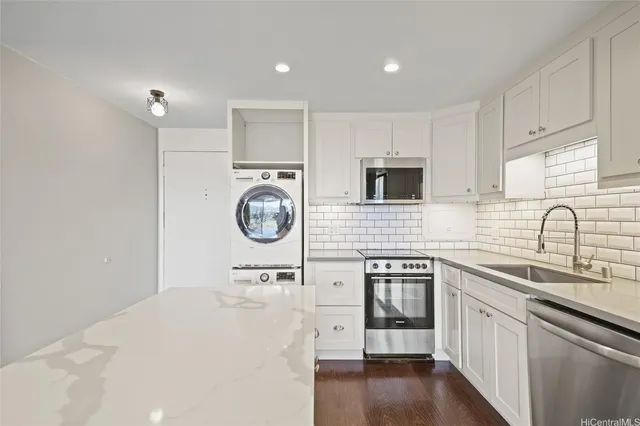 a kitchen with a sink cabinets and wooden floor