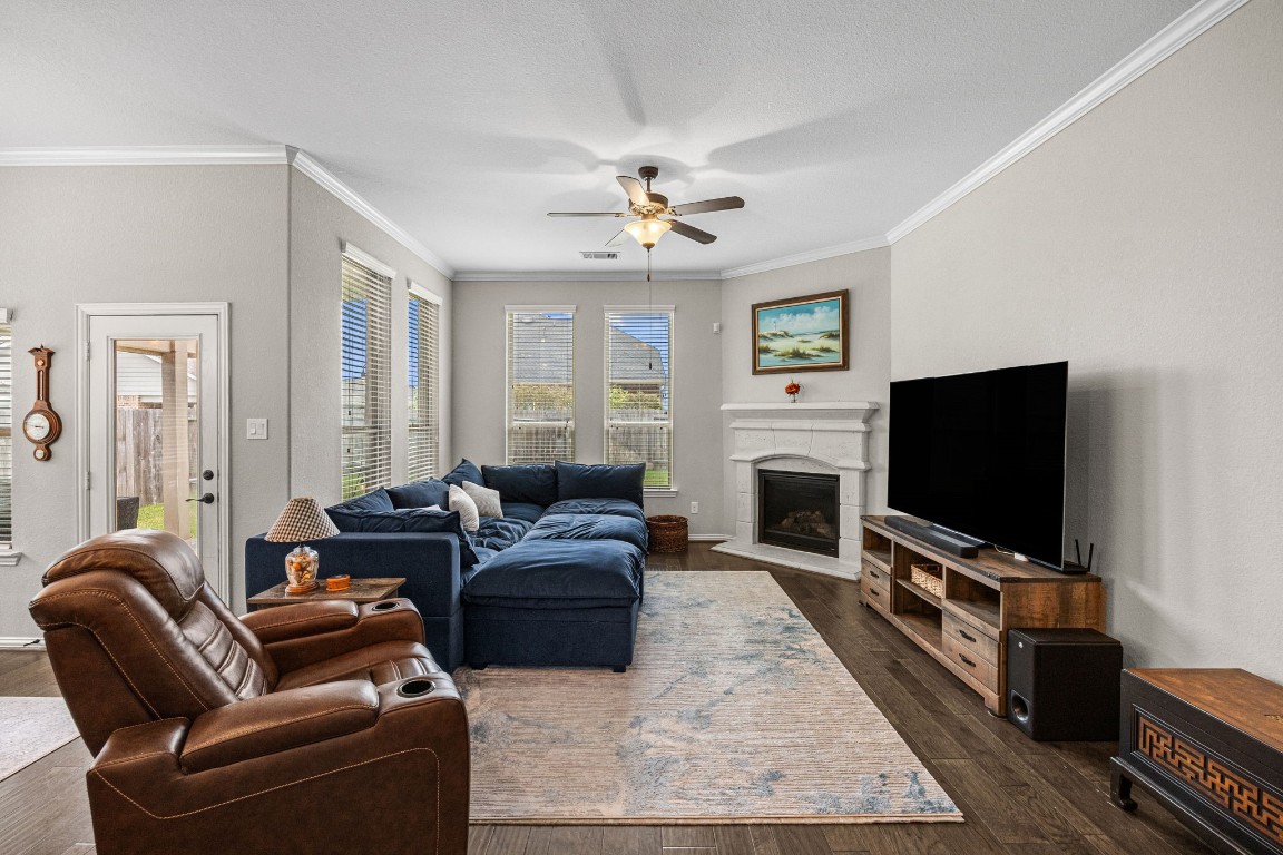 31521 Timber Grove Lane Spring, TX 77386 - Photo 13 of 30 The inviting living room boasts a fireplace, offering a warm and welcoming space to enjoy