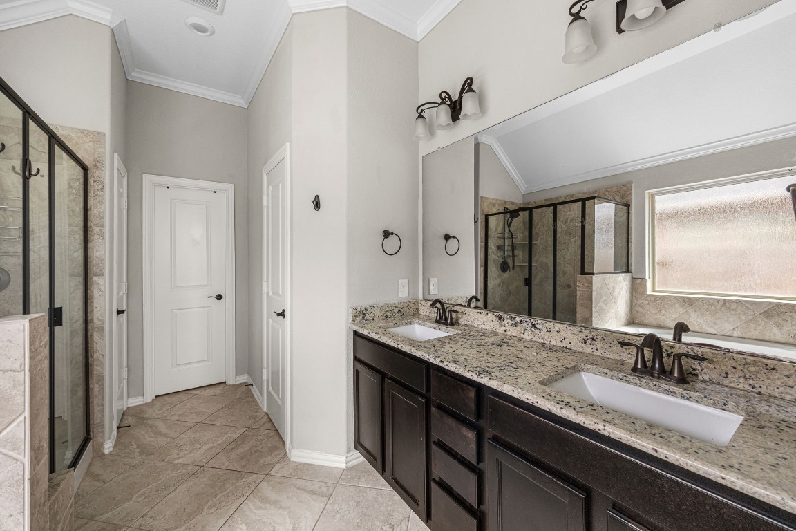 31521 Timber Grove Lane Spring, TX 77386 - Photo 17 of 30 Bright and functional primary bathroom featuring a dual-sink vanity with generous countertop area and deep under-sink cabinetry.
