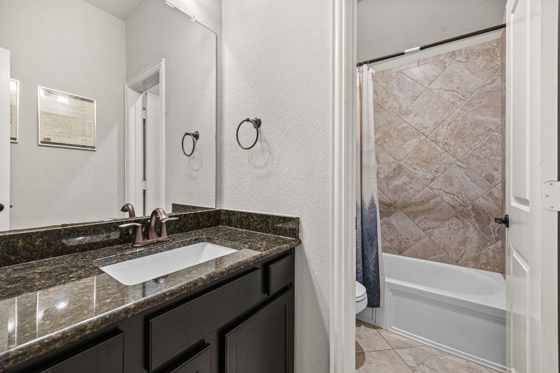 31521 Timber Grove Lane Spring, TX 77386 - Photo 20 of 30 The secondary bathroom offers a separate toilet and shower area, enhancing convenience and privacy.