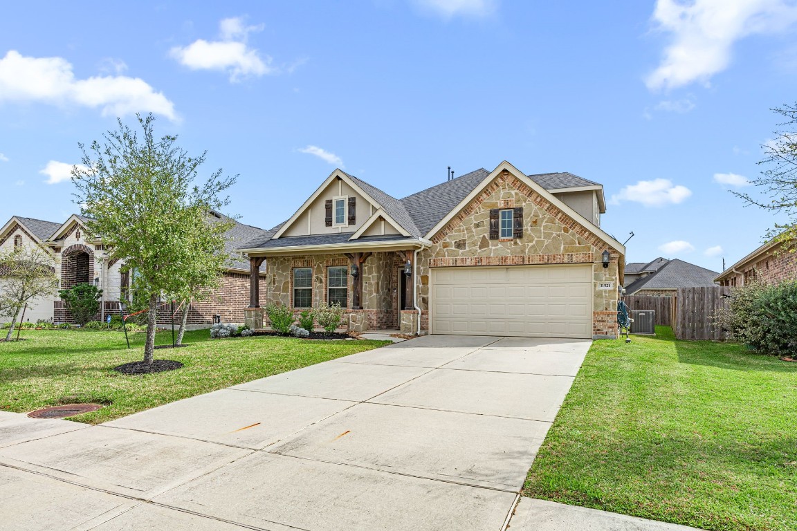 31521 Timber Grove Lane Spring, TX 77386 - Photo 2 of 30 This double-wide driveway leads to a two car garage.