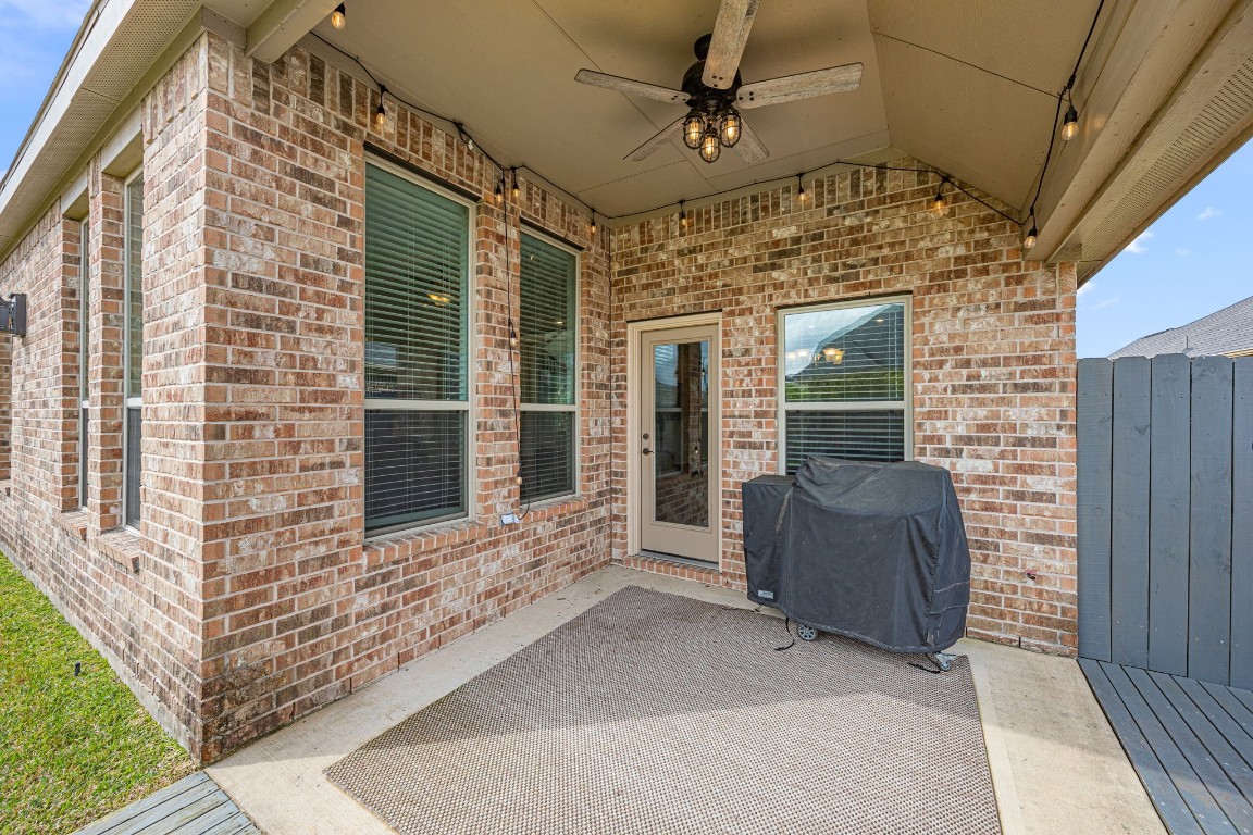 31521 Timber Grove Lane Spring, TX 77386 - Photo 27 of 30 You will love this covered patio with ceiling fans and cozy seating, overlooking a large, fenced backyard. Perfect for outdoor relaxation and entertaining.