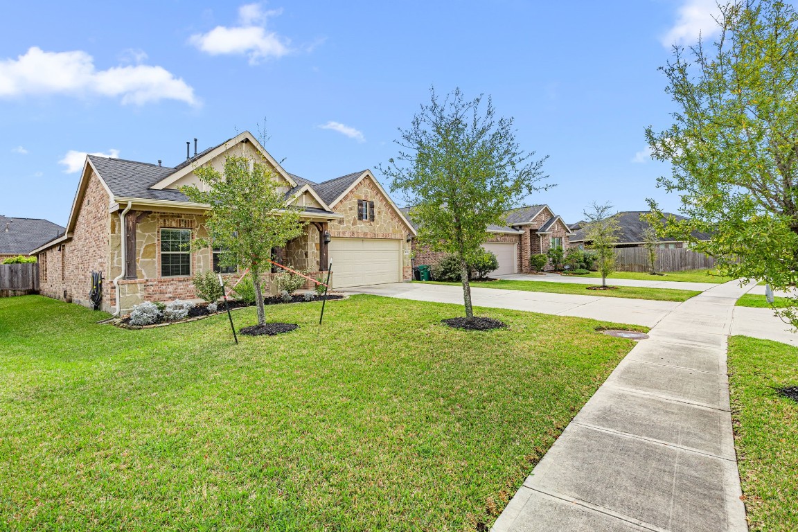 31521 Timber Grove Lane Spring, TX 77386 - Photo 3 of 30 Enjoy spacious front and side yards with convenient sidewalk access