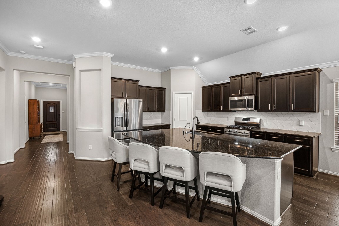 31521 Timber Grove Lane Spring, TX 77386 - Photo 6 of 30 The open kitchen flows into the living and breakfast rooms and includes a large island with seating for four or more.