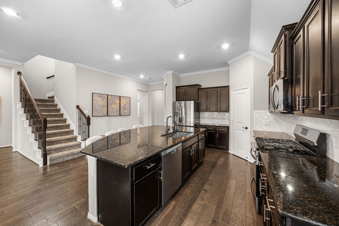 31521 Timber Grove Lane Spring, TX 77386 - Photo 8 of 30 The kitchen shines with granite countertops, stainless steel appliances, and gas cooking.