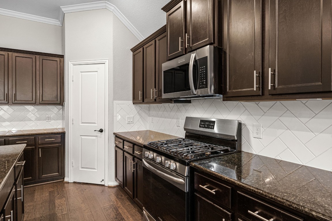 31521 Timber Grove Lane Spring, TX 77386 - Photo 9 of 30 Enjoy abundant cabinet and counter space, offering plenty of room for meal prep and organized storage.