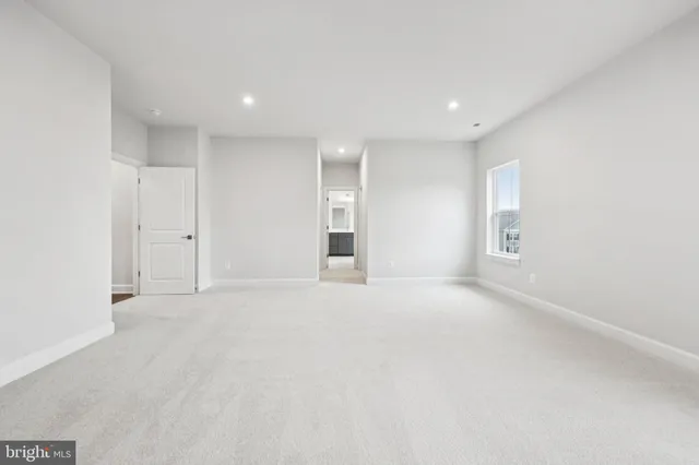 a spacious bathroom with a double vanity sink a large mirror and a bathtub