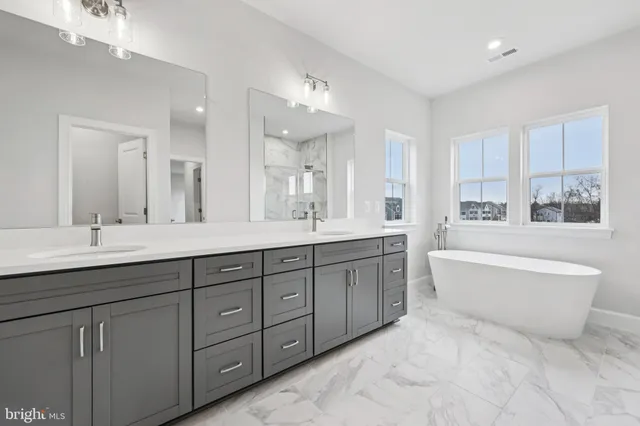a white bath tub sitting next to a window