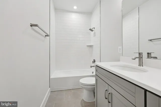 a bathroom with a double vanity sink toilet and a mirror