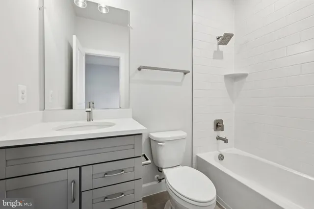 a view of a small space with wooden floor and a window
