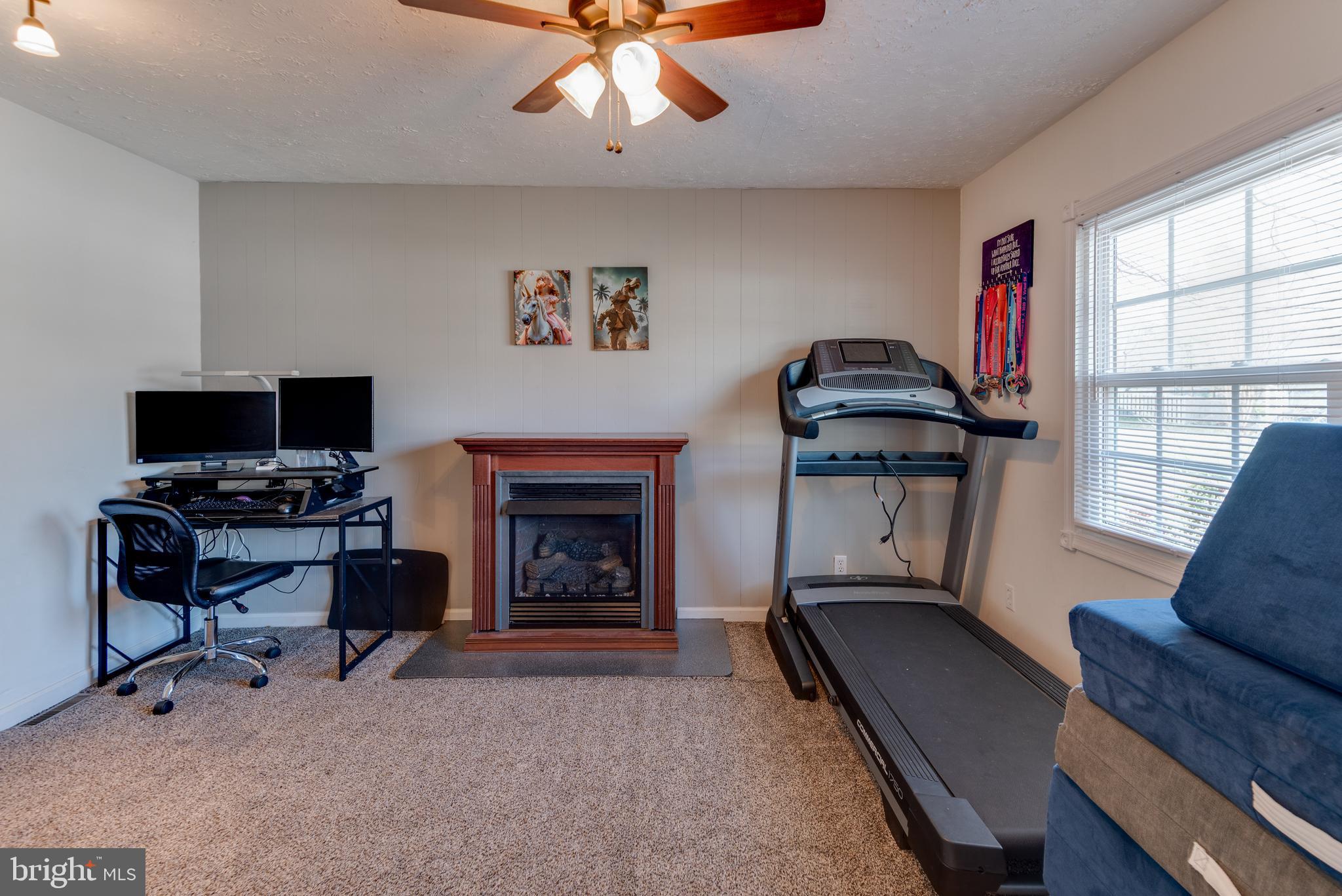 44125 Louisdale Road California, MD 20619 - Photo 11 of 44 a living room with furniture a flat screen tv and a fireplace