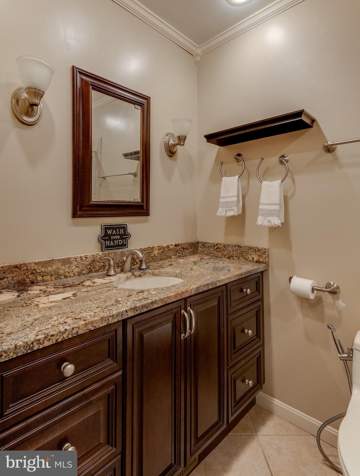 44125 Louisdale Road California, MD 20619 - Photo 13 of 44 a bathroom with a granite countertop sink and a mirror