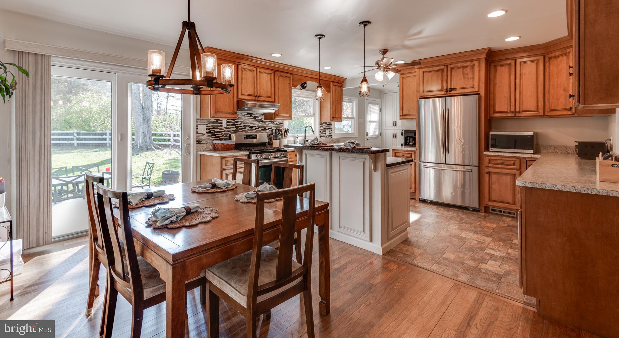 44125 Louisdale Road California, MD 20619 - Photo 2 of 44 a kitchen with refrigerator dining table and chairs