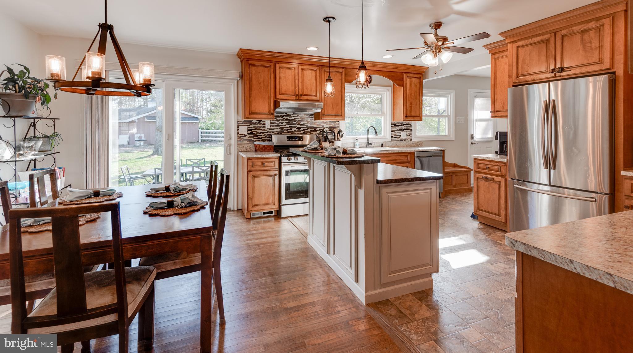 44125 Louisdale Road California, MD 20619 - Photo 3 of 44 a kitchen with stainless steel appliances granite countertop furniture wooden floor and a window