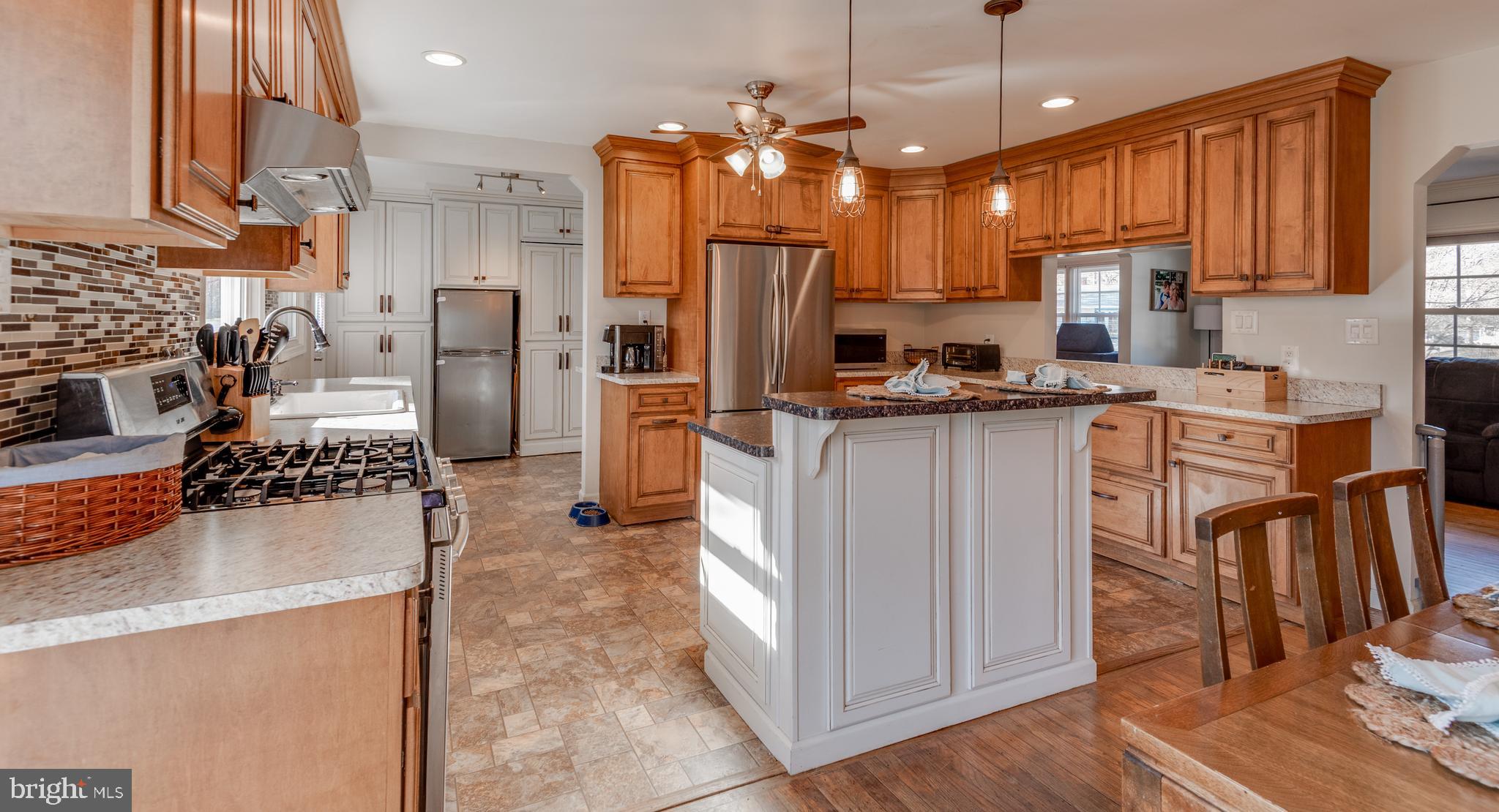 44125 Louisdale Road California, MD 20619 - Photo 4 of 44 a kitchen with stainless steel appliances granite countertop a refrigerator a stove a sink dishwasher and white cabinets with wooden floor