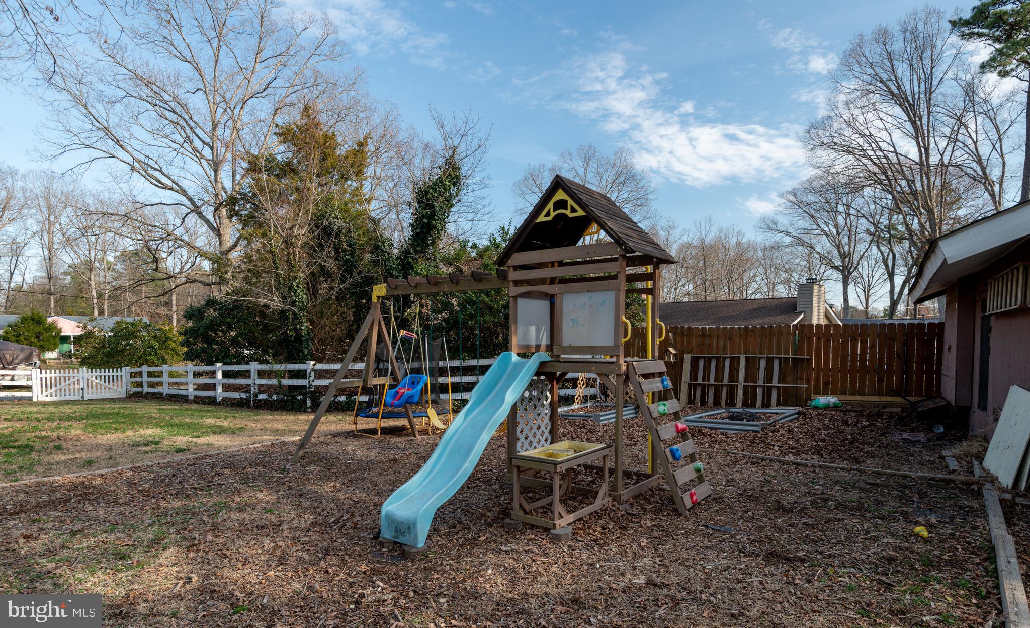 44125 Louisdale Road California, MD 20619 - Photo 43 of 44 a view of a house with a yard patio and fire pit