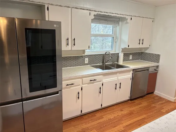 a kitchen with a sink and cabinets