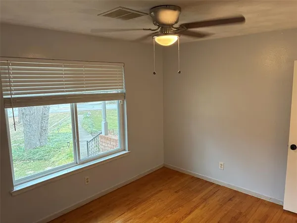 a view of a room with window and wooden floor