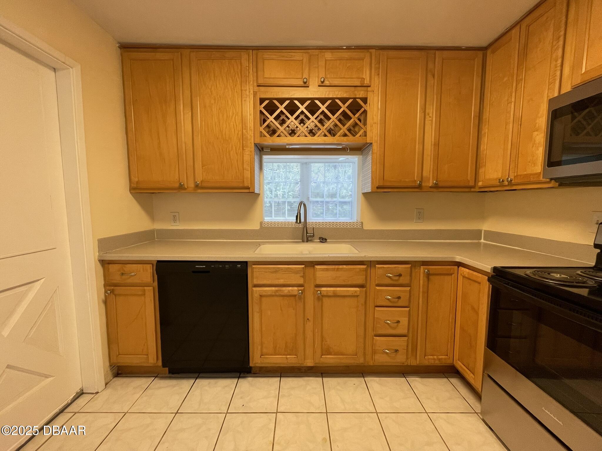 525 Tarragona Way Daytona Beach, FL 32114 - Photo 14 of 47 a kitchen with stainless steel appliances granite countertop a stove a sink and a microwave