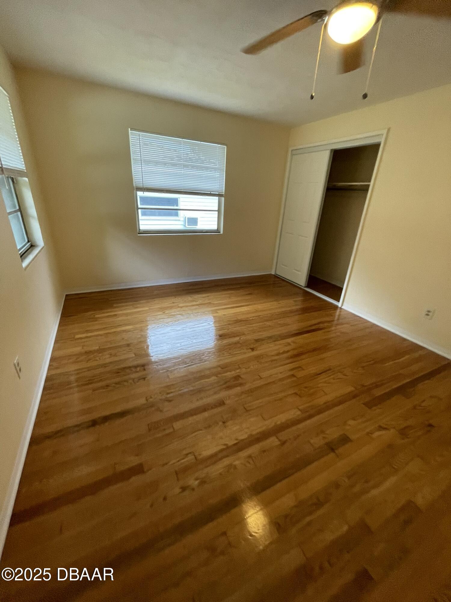 525 Tarragona Way Daytona Beach, FL 32114 - Photo 24 of 47 a view of an empty room with window and wooden floor