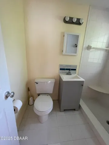 a white toilet sitting next to a bathroom sink