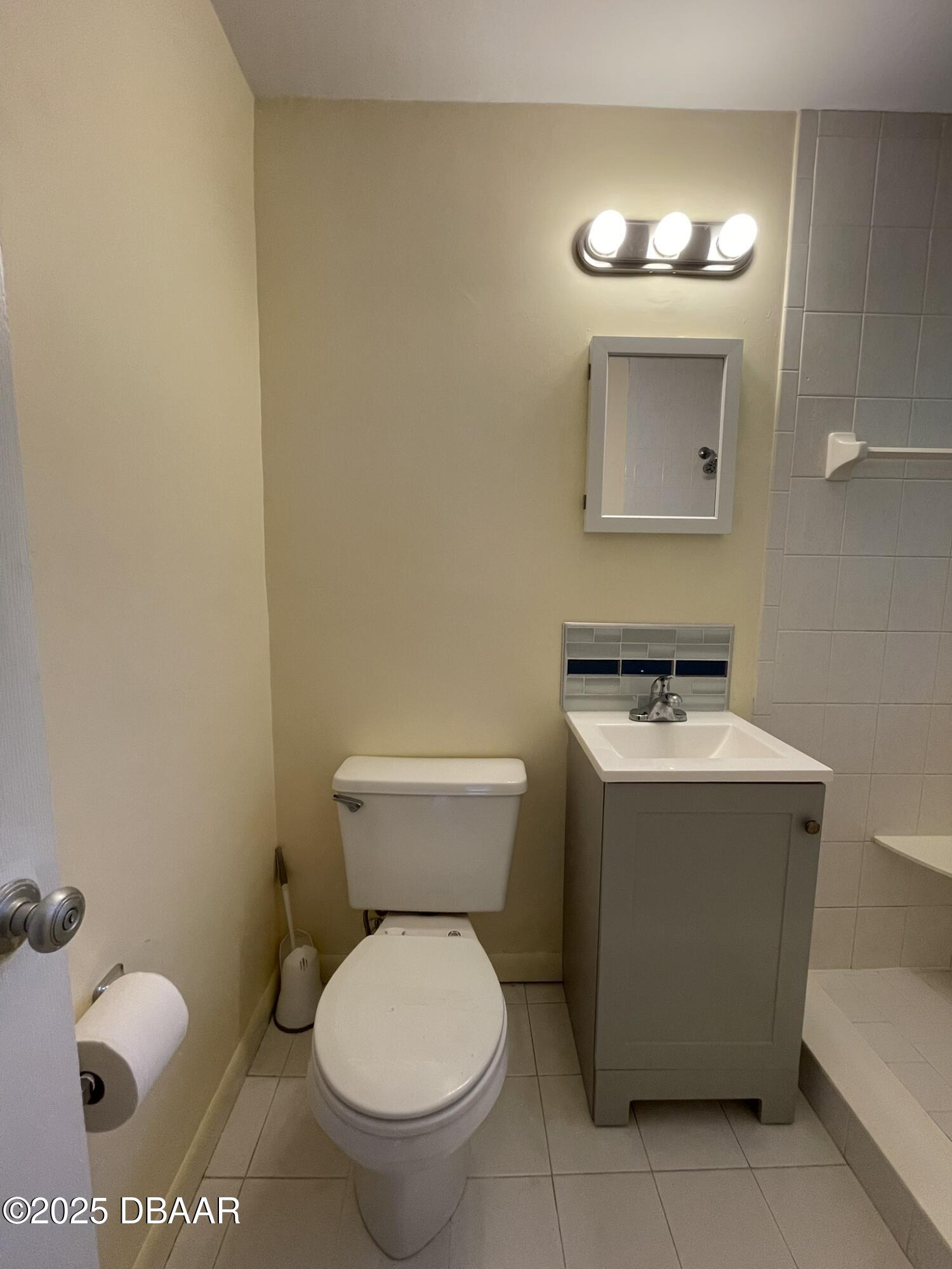 525 Tarragona Way Daytona Beach, FL 32114 - Photo 31 of 47 a bathroom with a toilet sink and mirror