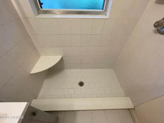 a bathroom with a shower and a sink