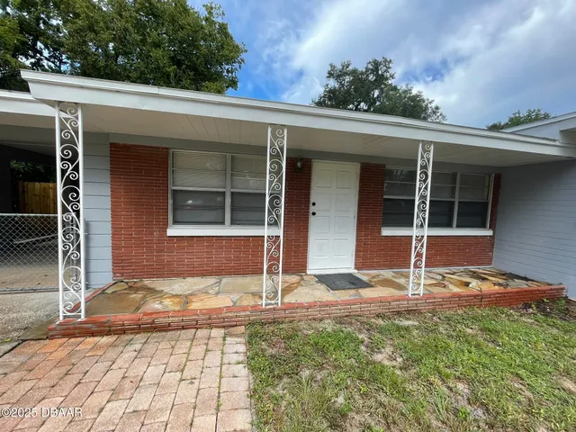a view of house with backyard and porch