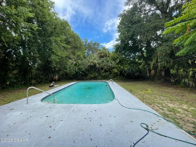 a view of a swimming pool with a yard