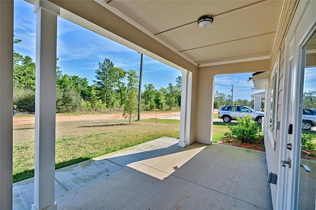 135 Hartford Street Hawthorne, FL 32640 - Photo 45 of 45 a view of a porch with a floor to ceiling window and wooden fence