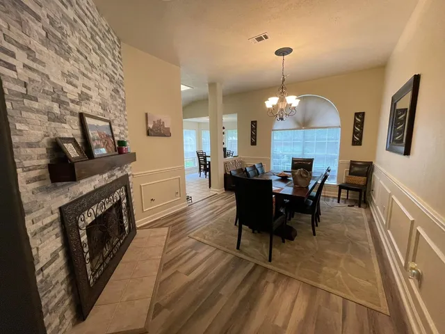 a dining room with furniture and chandelier