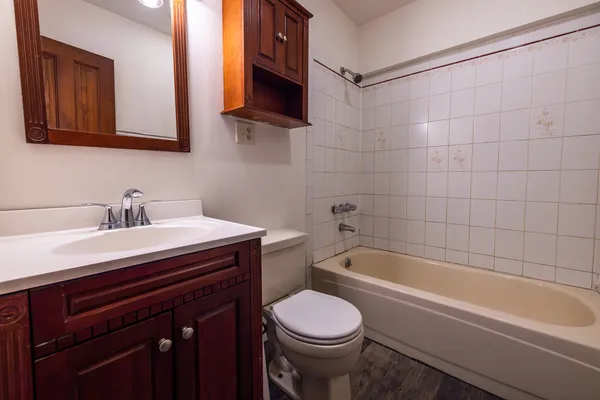 a bathroom with a sink a toilet and bathtub