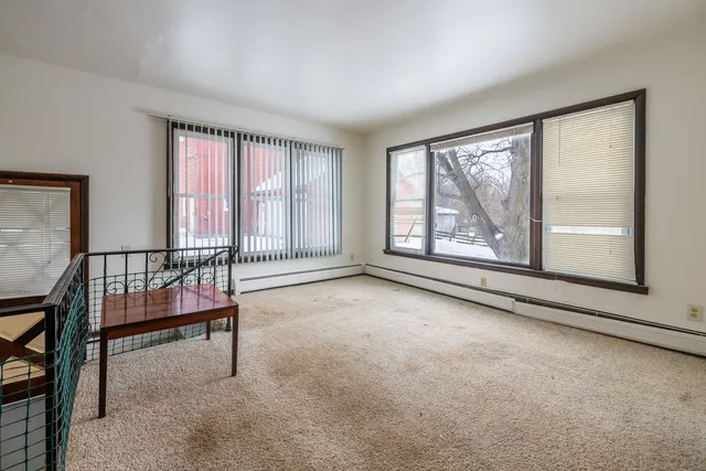 a kitchen with stainless steel appliances a sink cabinets and a window