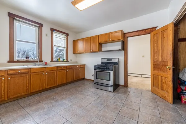 a kitchen with a stove a sink and a refrigerator