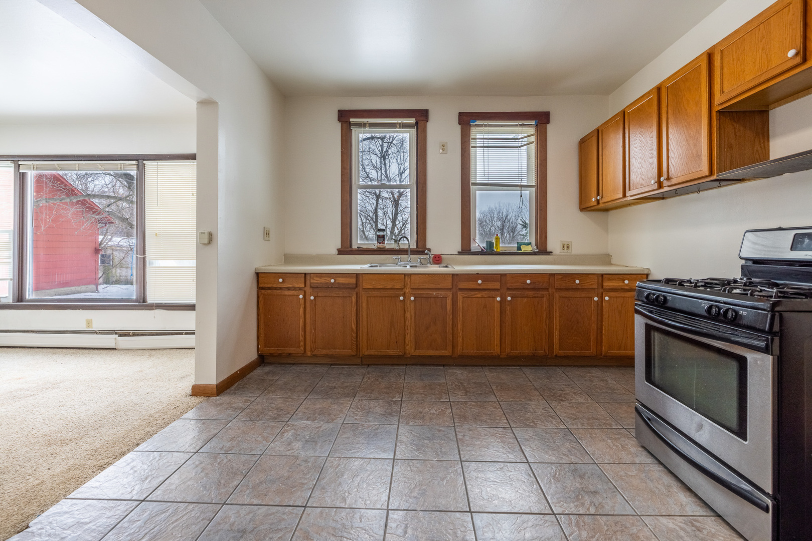 39520 North Kilbourne Road Wadsworth, IL 60083 - Photo 22 of 44 a kitchen with a stove a sink and a refrigerator