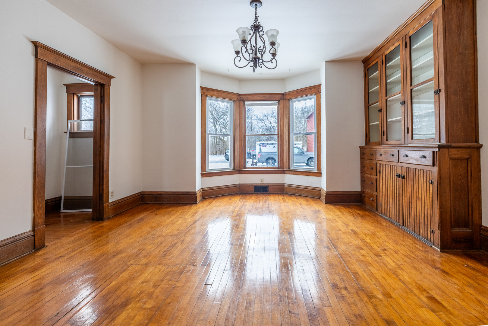 39520 North Kilbourne Road Wadsworth, IL 60083 - Photo 4 of 44 a view of an empty room with a window and wooden floor