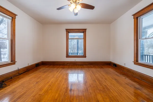 a view of a room with wooden floors and a window