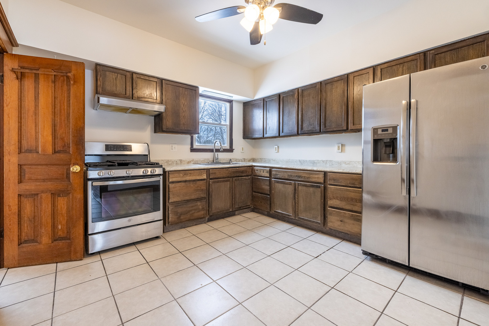 39520 North Kilbourne Road Wadsworth, IL 60083 - Photo 7 of 44 a kitchen with a stove sink and refrigerator