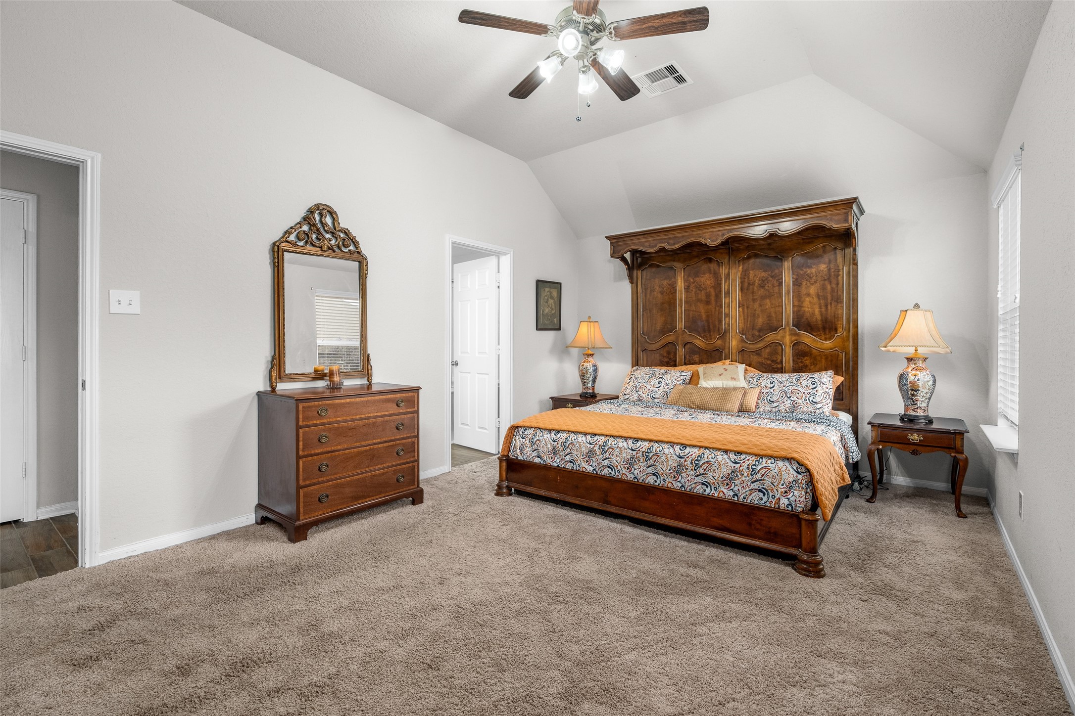 4518 Antero Court Rosenberg, TX 77471 - Photo 12 of 33 a bedroom with a bed and a chandelier