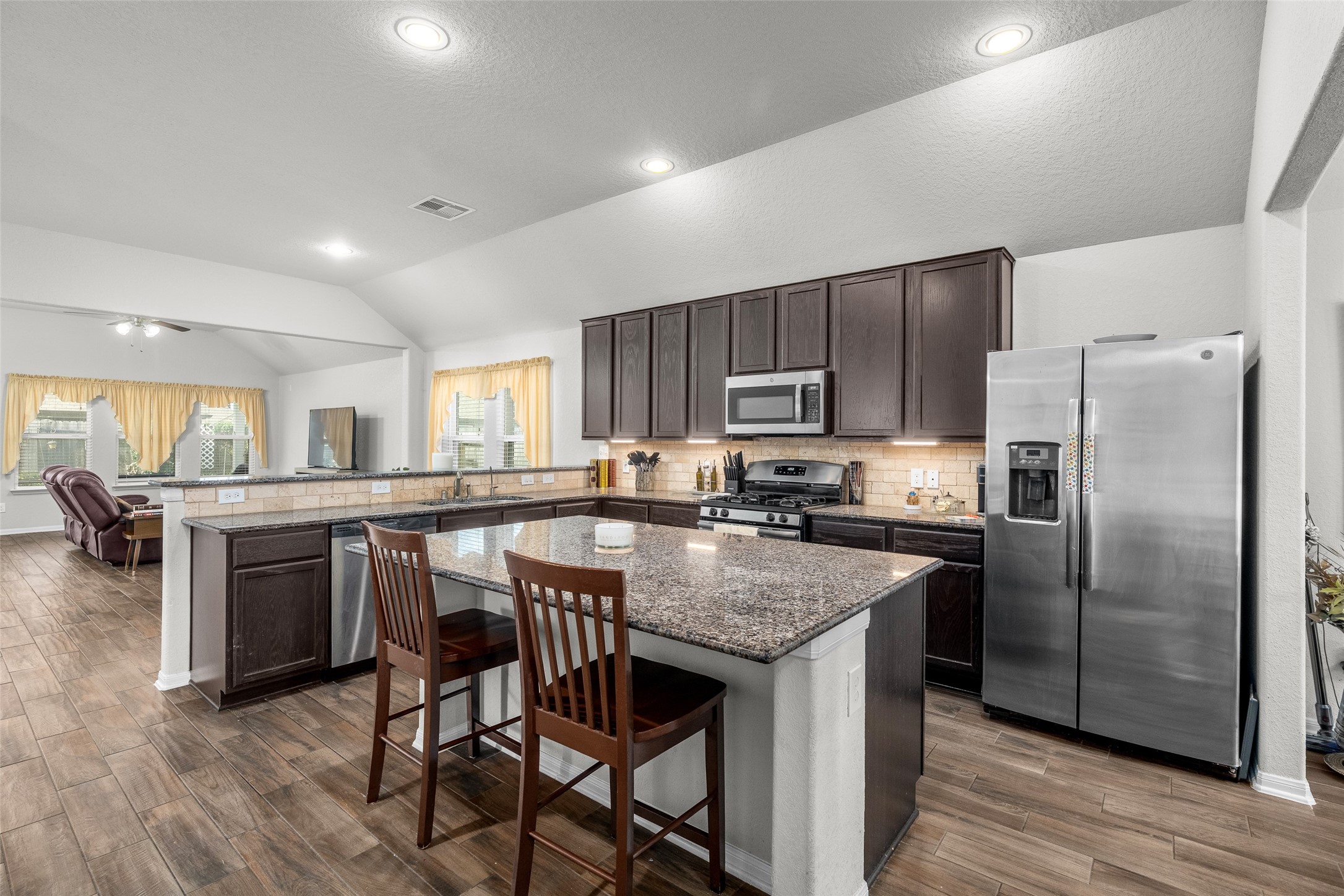 4518 Antero Court Rosenberg, TX 77471 - Photo 17 of 33 a kitchen with stainless steel appliances granite countertop a kitchen island hardwood floor and a sink
