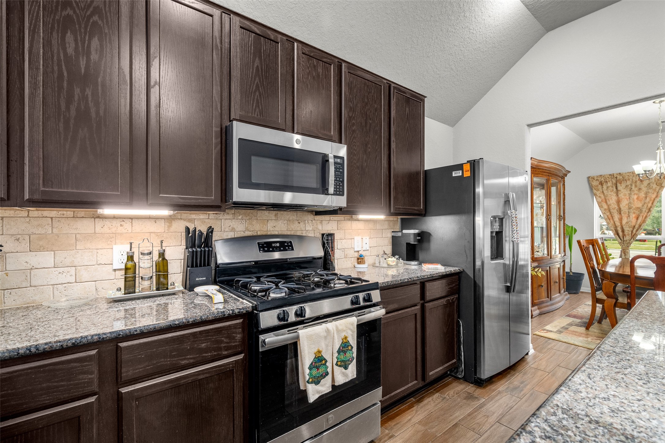 4518 Antero Court Rosenberg, TX 77471 - Photo 19 of 33 a kitchen with granite countertop wooden cabinets stainless steel appliances and a counter space
